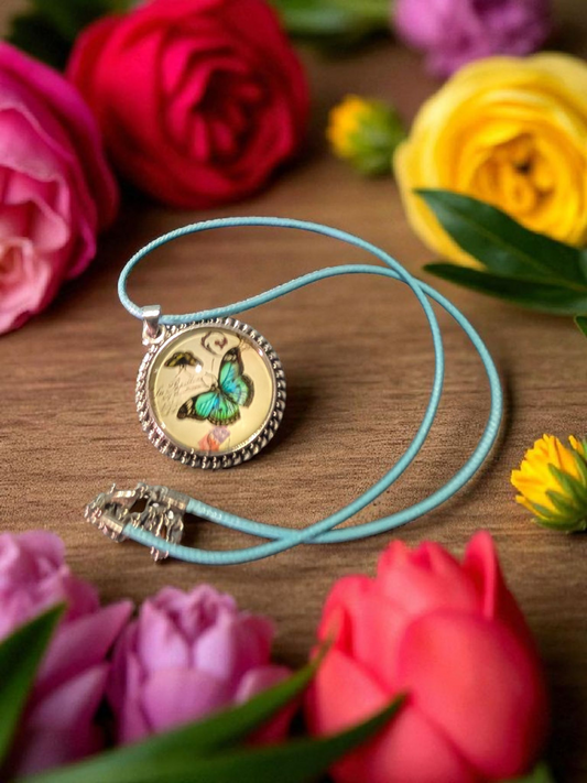 Butterfly Cabochon pendant on a blue satin cord